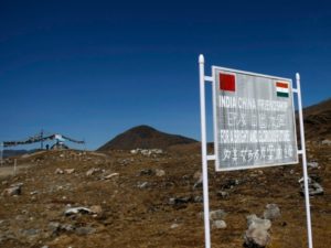 A signboard is seen from the Indian side of the Indo-China border at Bumla