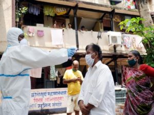 Healthcare workers conduct a check-up of the COVID-19 test at Labour Camp