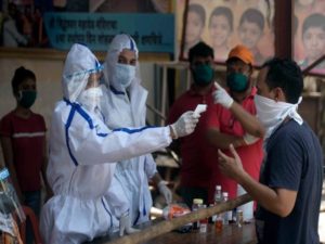 Medics check the temperature of residences of Munshi Compound, Gulshan Nagar during a nationwide lockdown