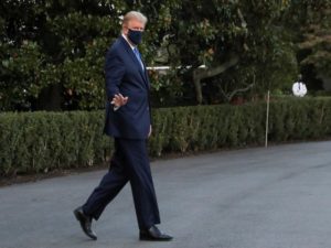 U.S. President Trump waves while walking to the Marine One helicopter as he departs for Walter Reed Medical Center from the White House in Washington