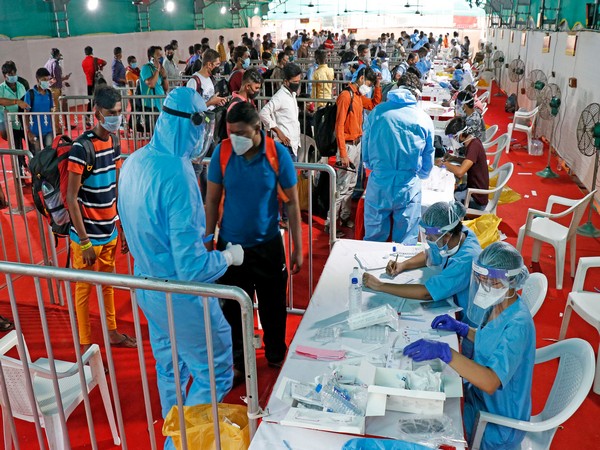 Health workers wearing personal protective equipment (PPE) during a rapid antigen testing