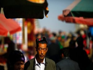 An ethnic Uighur man walks along a market in downtown Turpan, Xinjiang province