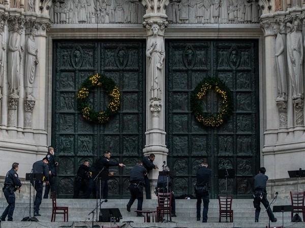 Police officers surround a suspect who was shooting outside the Cathedral Church of St. John the Divine in Manhattan