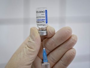 A medical worker fills a syringe with Sputnik V (Gam-COVID-Vac) vaccine as she prepares to vaccinate a Russian Army service member at a clinic in the city of Rostov-On-Don