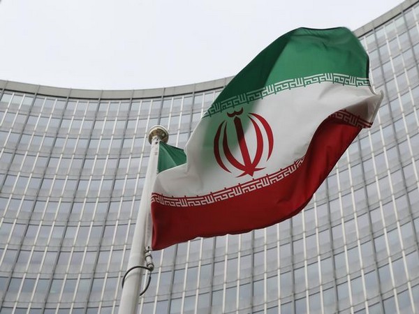 An Iranian flag flutters in front of the IAEA headquarters in Vienna