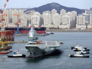 China's first domestically developed aircraft carrier with aircraft on its deck, departs the port for its fourth sea trial in Dalian