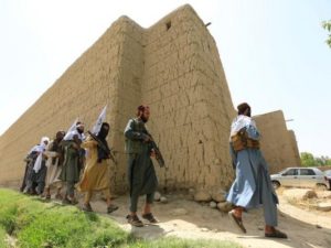 Taliban walk as they celebrate ceasefire in Ghanikhel district of Nangarhar province, Afghanistan