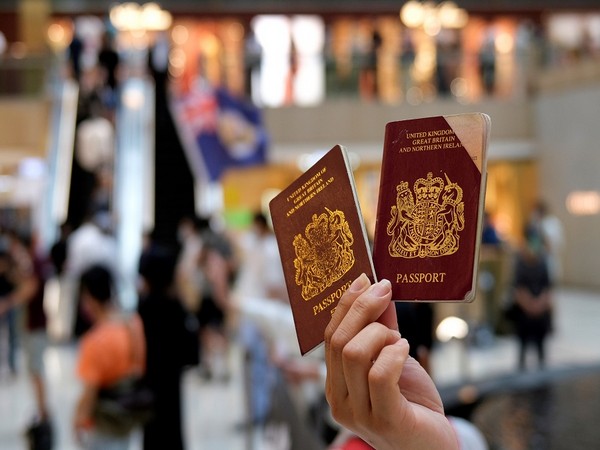 A pro-democracy demonstrator holds British National Overseas (BNO) passports during a protest against new national security legislation in Hong Kong