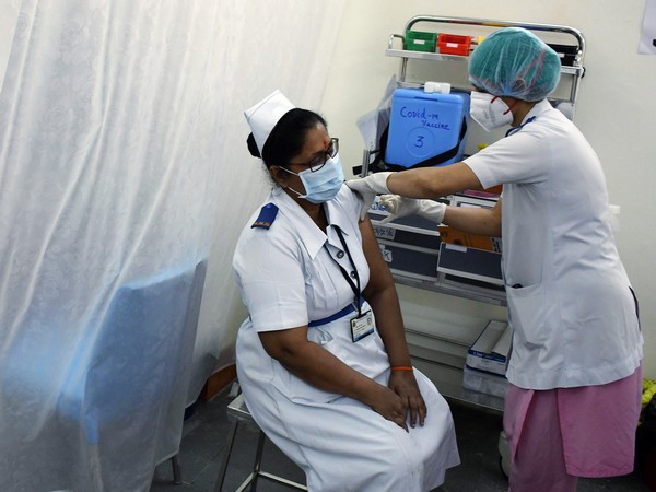 A medic worker injects the COVID-19 vaccine to a health worker