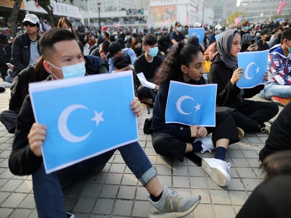 Hong Kong protesters hold East Turkestan Uyghur flags at a rally in support of Xinjiang Uighurs' human rights in Hong Kong