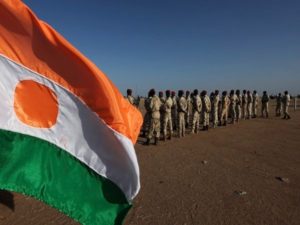 Soldiers stand at attention before the arrival of the Prime Minister of Niger Brigi Rafini at the "Cure Salee" festival in Ingal