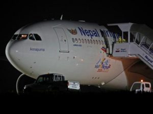 An official in protective suite prepares to evacuate 175 Nepalese nationals from a Nepal Airlines Airbus A330-200 plane arriving from coronavirus-stricken Chinese city of Wuhan before they were sent to be quarantine at Tribhuvan International Airport in Ka