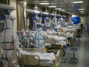 Medical workers in protective suits attend to novel coronavirus patients at the intensive care unit (ICU)