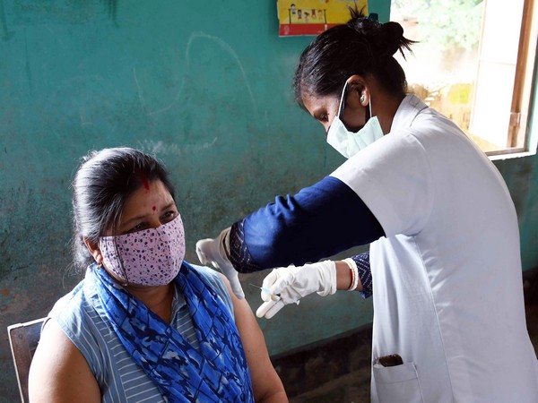 A medic inoculates the first dose of the COVID-19 vaccine to a beneficiary