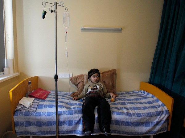 A child with leukaemia lies on her bed in the onco-hematology department of the Iashvili Central Children's Hospital in Tbilisi