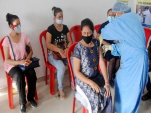 A medic inoculates the dose of the COVID19 vaccine to a beneficiary