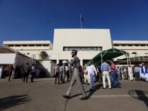 A traffic policeman walks in front of the parliament building during a session of the national assembly in Islamabad