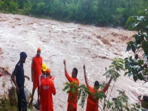 NDRF personnel conducts a search and rescue operation search in the wake of the Himachal Pradesh flash flood