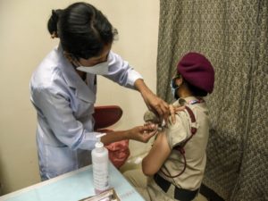 A Delhi Police personnel gets the COVID-19 vaccine