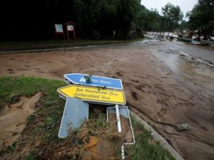 A sign lies on the ground at a flood-affected area in Schuld