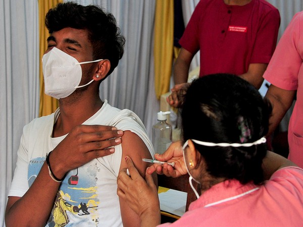 A beneficiary receives a dose of the COVID-19 vaccine