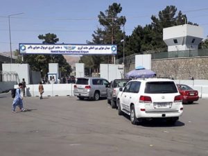 Afghan police check the cars at the entrance gate of Hamid Karzai International Airport in Kabul