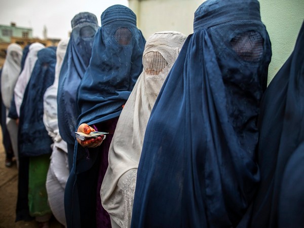 Afghan women stand in line while waiting for their turn to vote at a polling station in Mazar-i-sharif