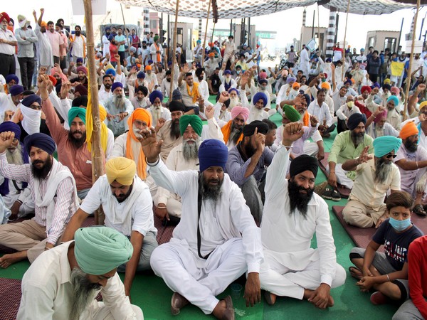 Farmers shout slogans during a protest against the agricultural bill