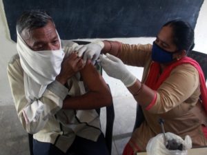 A medic inoculates the dose of the COVID19 vaccine to a beneficiary