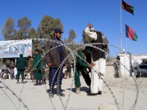 Security personnel frisk a man in the southern border town of Spin Boldak