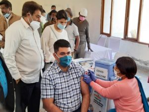 A medic inoculates a dose of COVID-19 vaccine to Vinay Pratap Singh Commissioner of Municipal Corporation Gurugram