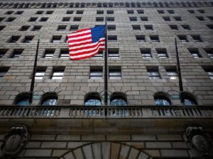 The U.S. flag flies outside The Federal Reserve Bank of New York