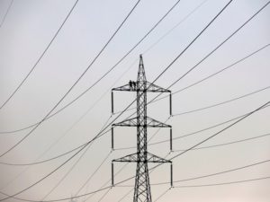 Technicians work to clean power transmission tower in Karachi