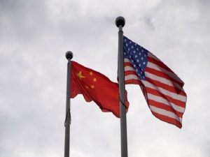 Chinese and U.S. flags flutter outside a company building in Shanghai