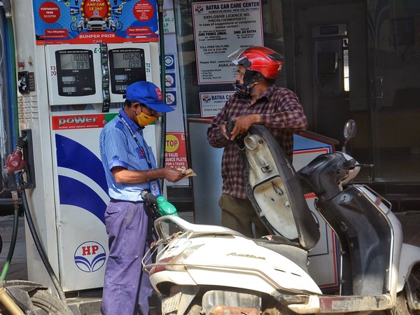 A petrol pump staff refills fuel in a vehicle during the continuous hike in fuel prices