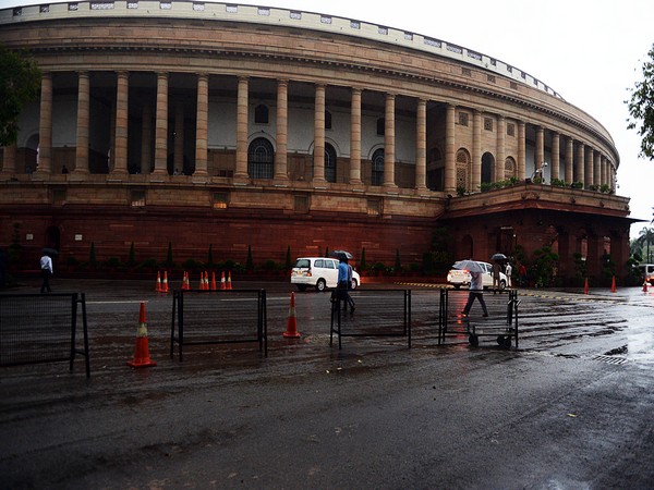 Parliament employees going to their office during the heavy rain in New Delhi