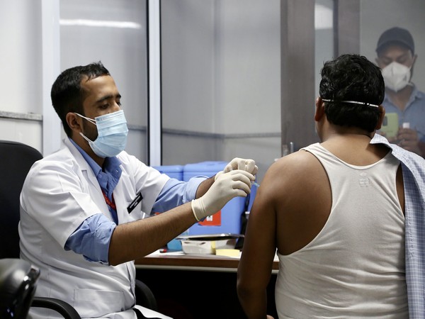 A beneficiary receives a dose of the COVID-19 vaccine inside the AIIMS vaccination centre