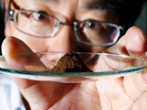 Kato, an associate professor of earth science at the University of Tokyo, displays a mud sample extracted from the depths of about 4,000 metres (13,123 ft) below the Pacific ocean surface in Tokyo