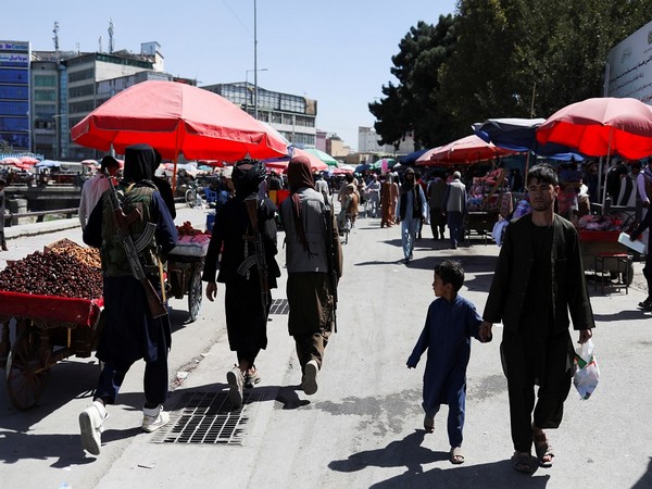 Taliban soldiers walk on a street in Kabul