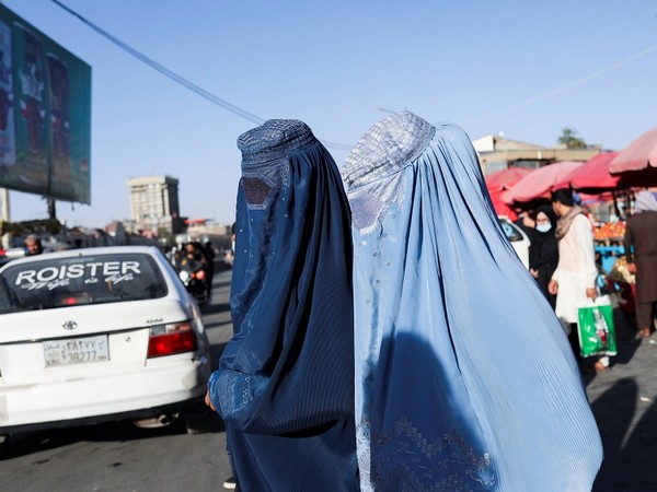 Afghan women walk down a street in Kabul