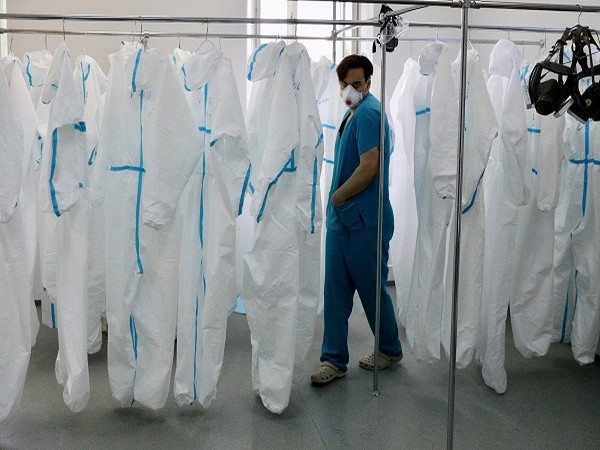 A medical specialist walks past personal protective equipment in a hospital in Moscow