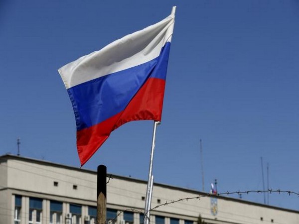 The Russian national flag is seen on a barricade near the seized office of the SBU state security service in Luhansk