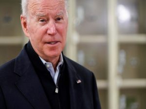 U.S. President Joe Biden fills boxes at a food bank in Philadelphia, Pennsylvania