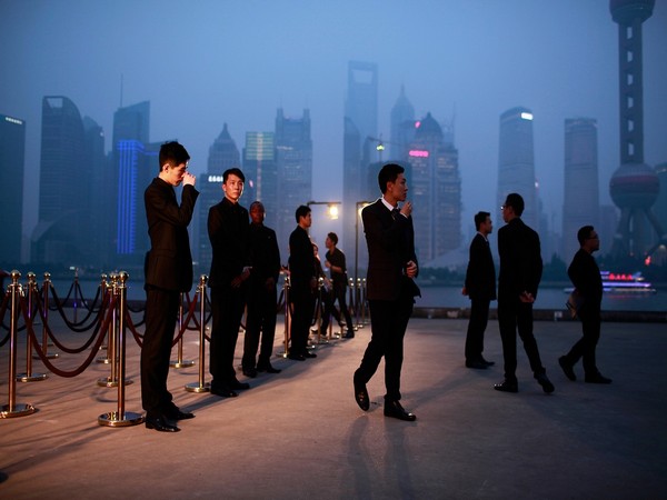 Security guards stand in front of a entrance of the Louis Vuitton fashion show in Shanghai