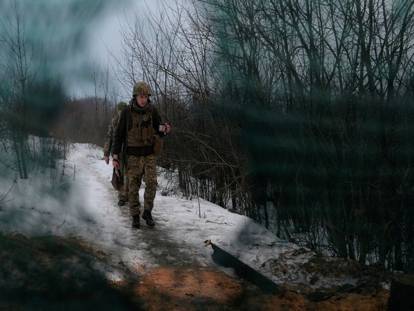 Service members of the Ukrainian armed forces walk at combat positions in Luhansk Region