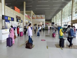 Passengers arrive to enter Prayagraj Airport following the resumption of domestic flight services