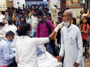 Health worker takes swab samples of migrants arriving from Maharashtra