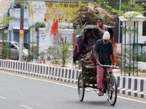 A rickshaw puller carries firewood during the COVID-19 lockdown