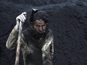 A labourer takes a break at a coal dump site outside Mazar-i-Sharif