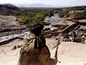 An ethnic Tajik fighter guards the entrance of the Panjshir Valley, north of Kabul as displaced Afgh..